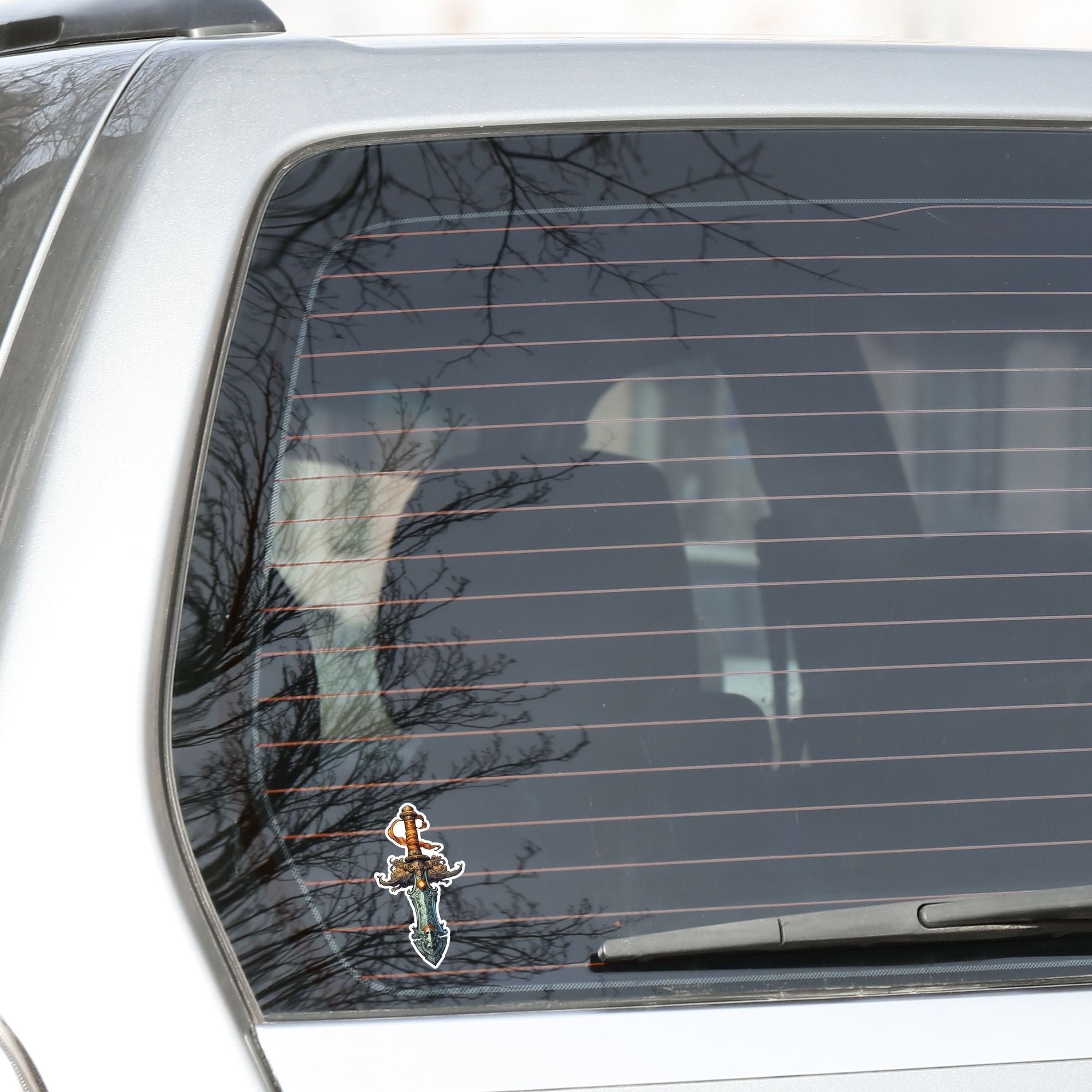 This image shows the Pirate Dagger Die-Cut Sticker on the back window of a car.