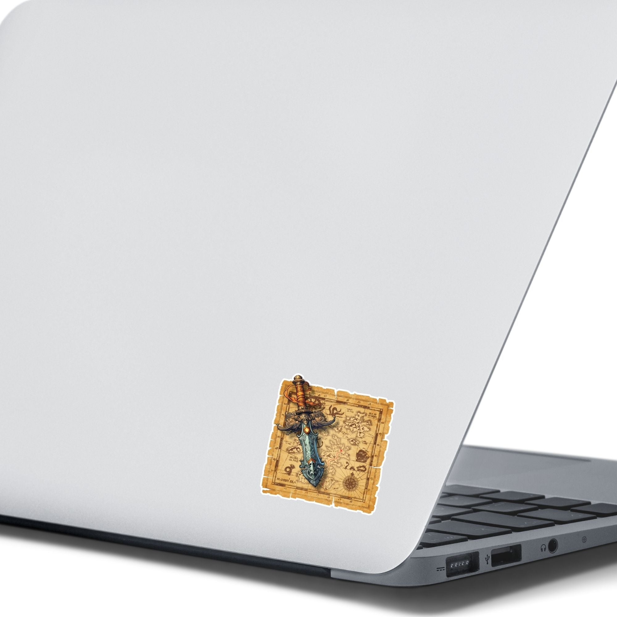 This image shows the Pirate Dagger on a Map Die-Cut Sticker on the back of an open laptop.