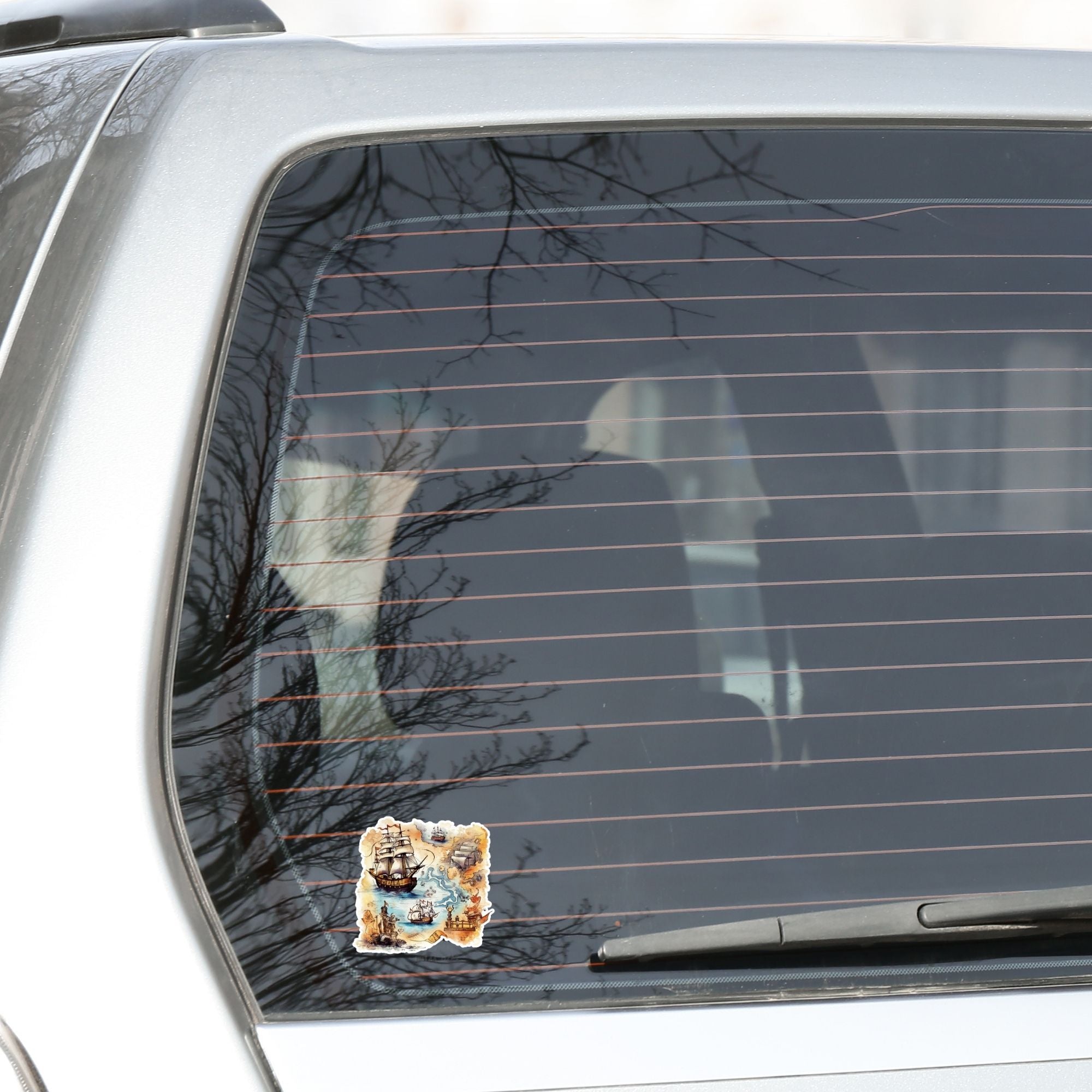 This image shows the Pirate Ship Map Die-Cut Sticker on the back window of a car.