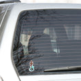 Load image into Gallery viewer, This image shows the Pirate Sword Die-Cut Sticker on the back window of a car.
