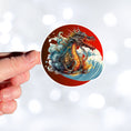 Load image into Gallery viewer, This image shows a hand holding the steampunk Japanese dragon sticker.
