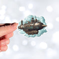 Load image into Gallery viewer, This image shows a hand holding the Steampunk Airship 4 Die-Cut Sticker.
