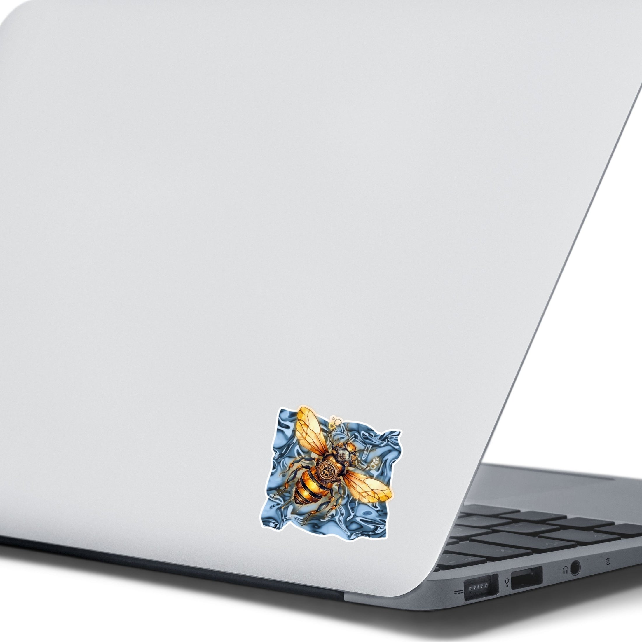 This image shows the steampunk bee sticker on the back of an open laptop.