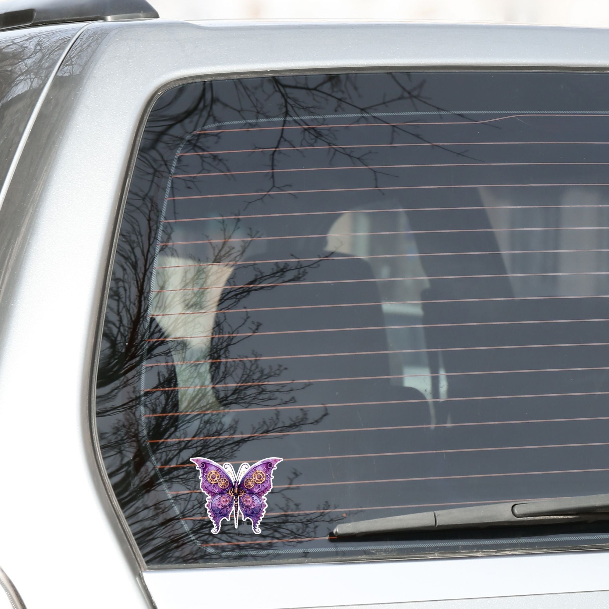 This image shows the Steampunk Butterfly 1 Die-Cut Sticker on the back window of a car.