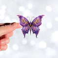 Load image into Gallery viewer, This image shows a hand holding the Steampunk Butterfly 1 Die-Cut Sticker.
