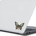 Load image into Gallery viewer, This image shows the Steampunk Butterfly 4 Die-Cut Sticker on the back of an open laptop.
