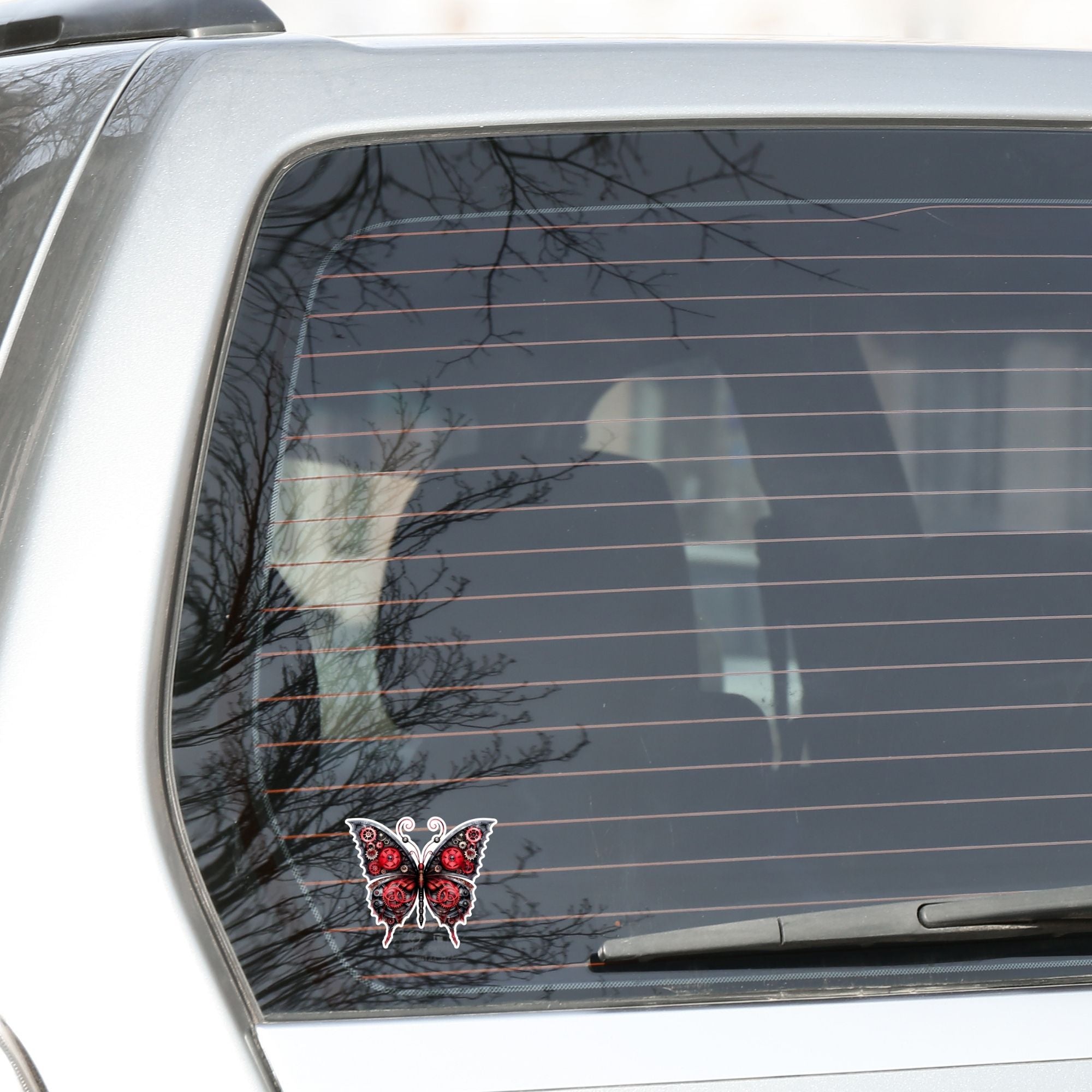 This image shows the Steampunk Butterfly 5 Die-Cut Sticker on the back window of a car.
