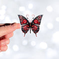 Load image into Gallery viewer, This image shows a hand holding the Steampunk Butterfly 5 Die-Cut Sticker.
