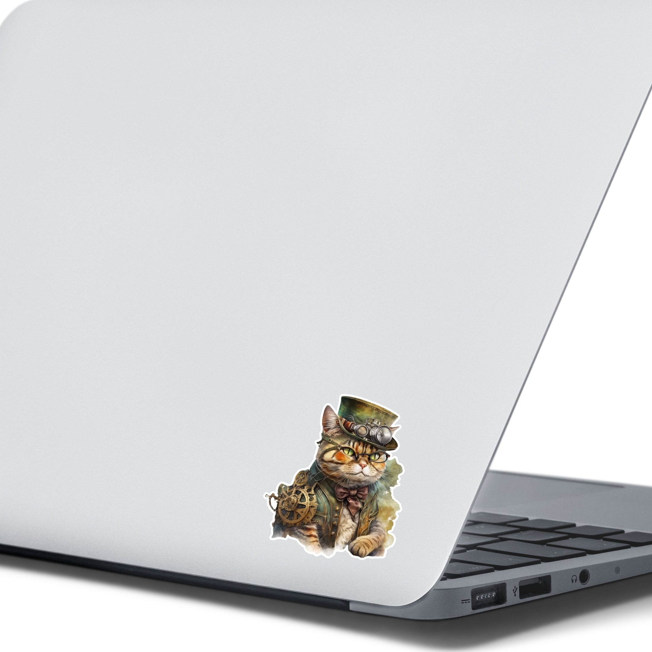 This image shows the steampunk cat sticker on the back of an open laptop.