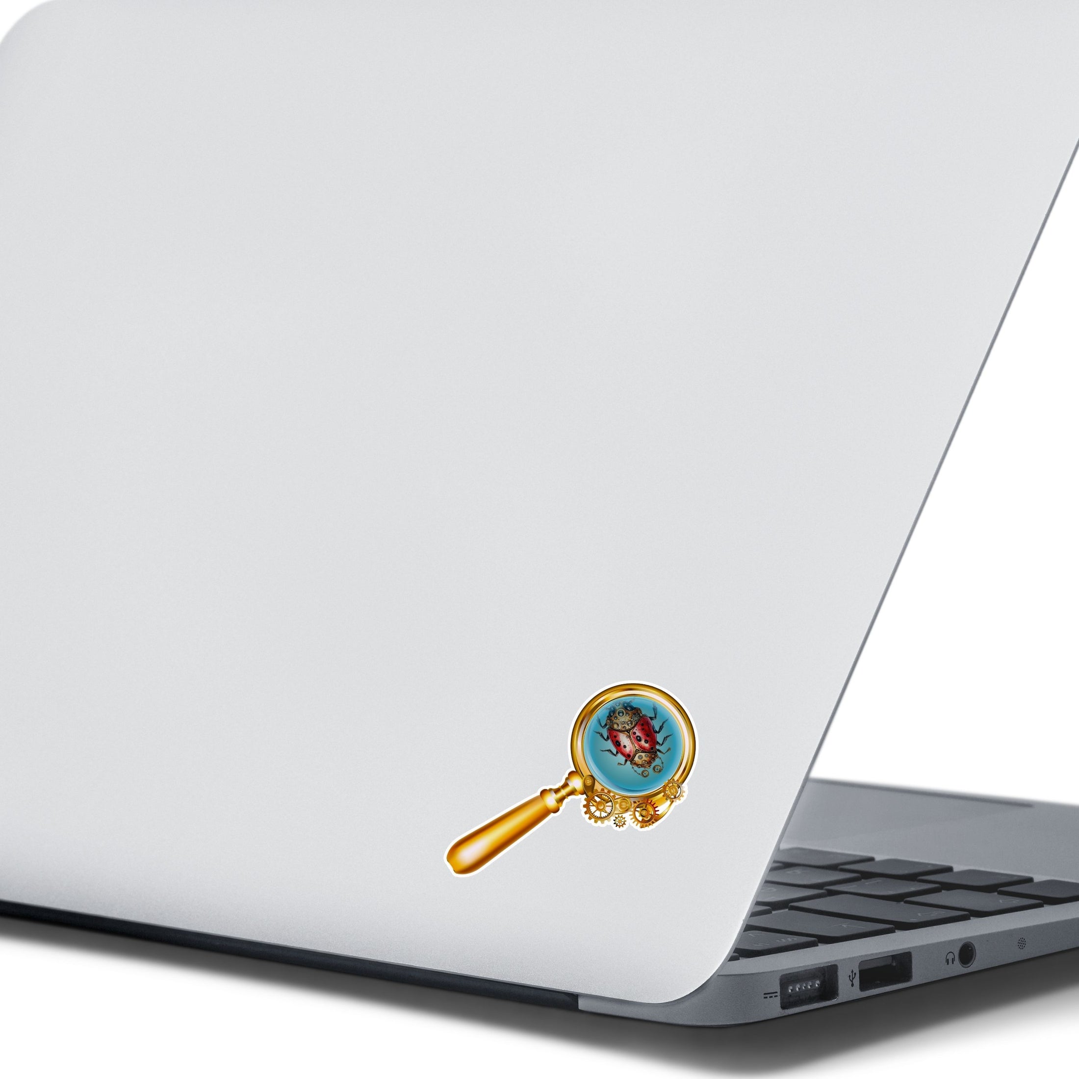 This image shows the steampunk ladybug sticker on the back of an open laptop.