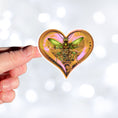 Load image into Gallery viewer, This image shows a hand holding the steampunk love bug sticker.
