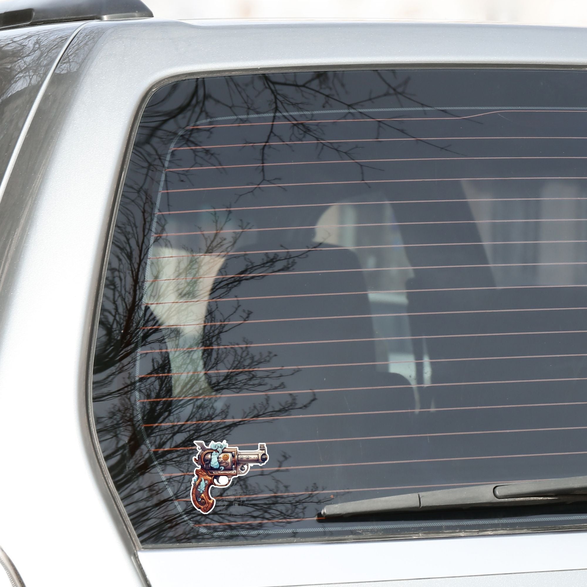 This image shows the Pirate Steampunk Pistol 1 Die-Cut Sticker on the back window of a car.