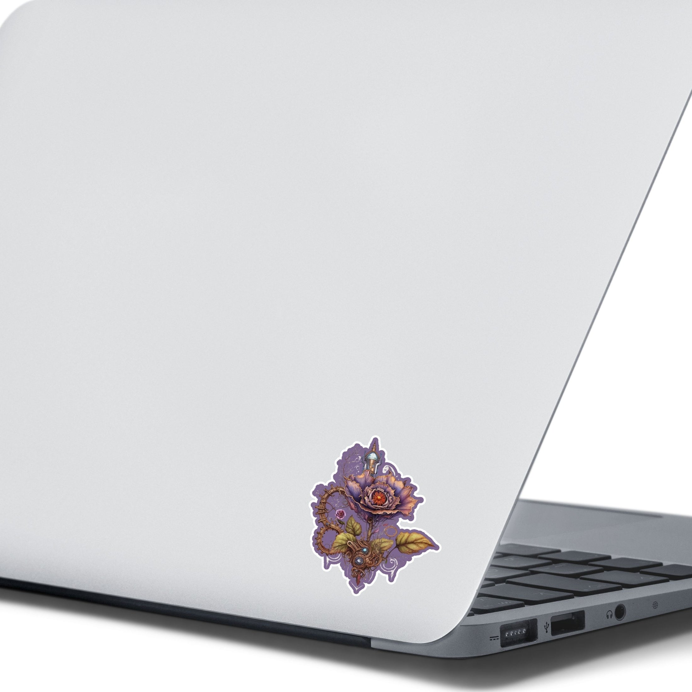 This image shows the steampunk rose sticker on the back of an open laptop.