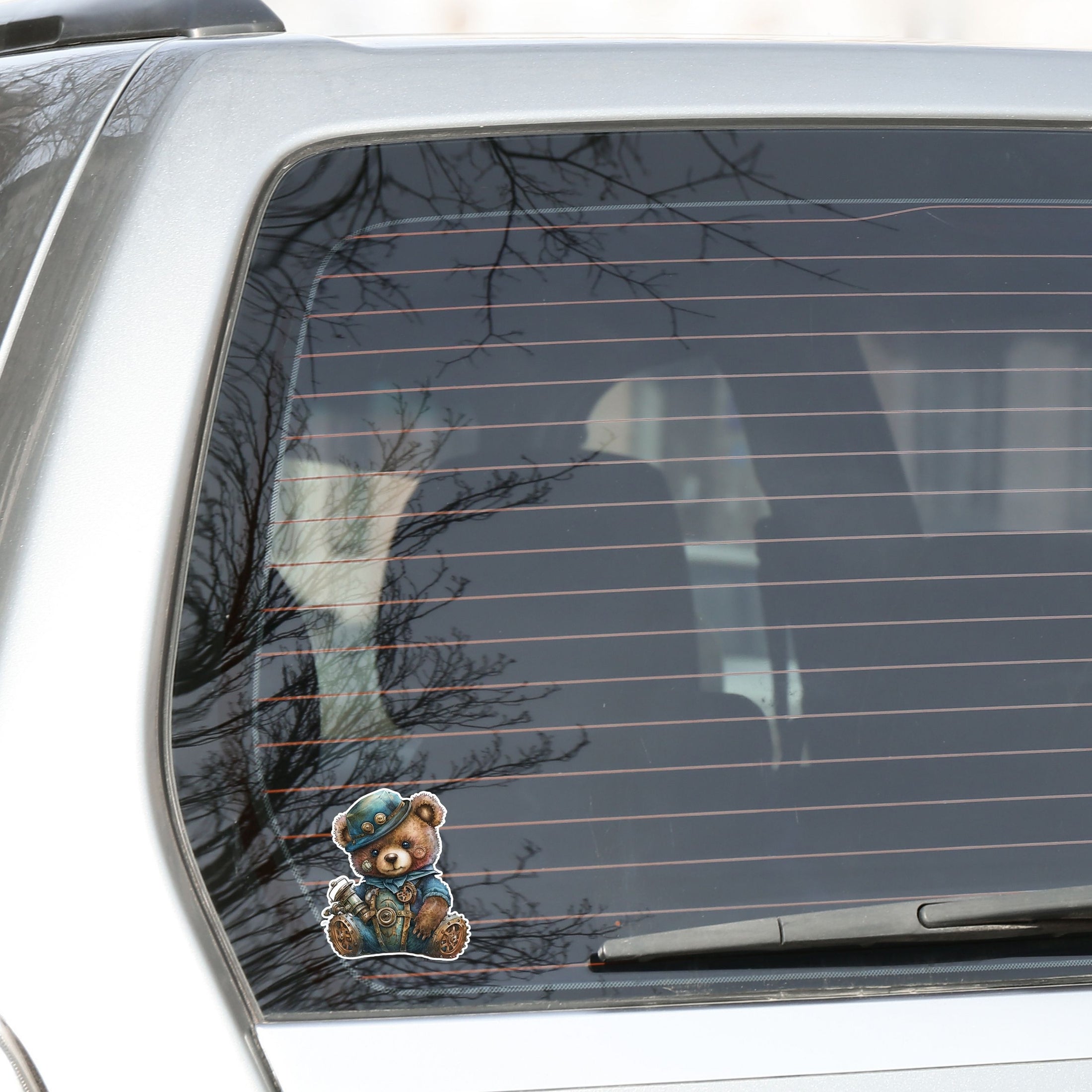 This image shows the steampunk teddy sticker on the back window of a car.