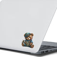 Load image into Gallery viewer, This image shows the steampunk teddy sticker on the back of an open laptop.
