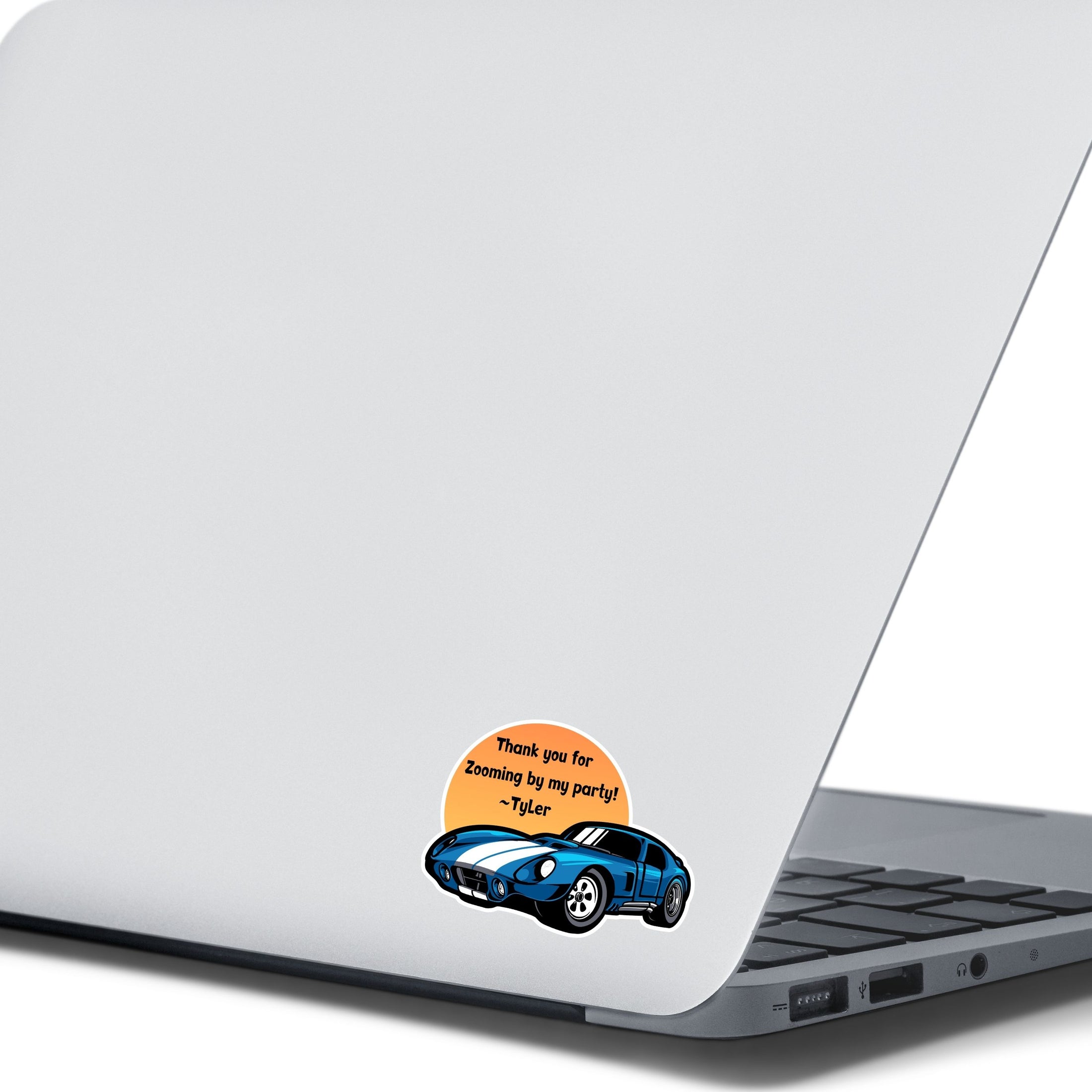 This image shows the zooming by sticker on the back of an open laptop.