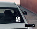 Load image into Gallery viewer, Love baseball? Then show it with this baseball love square vinyl decal! Available in 4 sizes and 10 colors, these vinyl decals make great gifts for everyone. This image shows the baseball love square decal on the back window of a car. 

