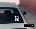 Load image into Gallery viewer, Love your pets? Then show it with this paw love square! Available in 4 sizes and 10 colors, these vinyl decals make great gifts for everyone. This image shows the Paw Love Square on the back window of a car.
