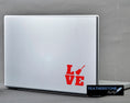 Load image into Gallery viewer, Love the guitar? Then show it with this acoustic guitar love square! Available in 4 sizes and 10 colors, these vinyl decals make great gifts for everyone. This image shows the acoustic guitar love square on the back of an open laptop..
