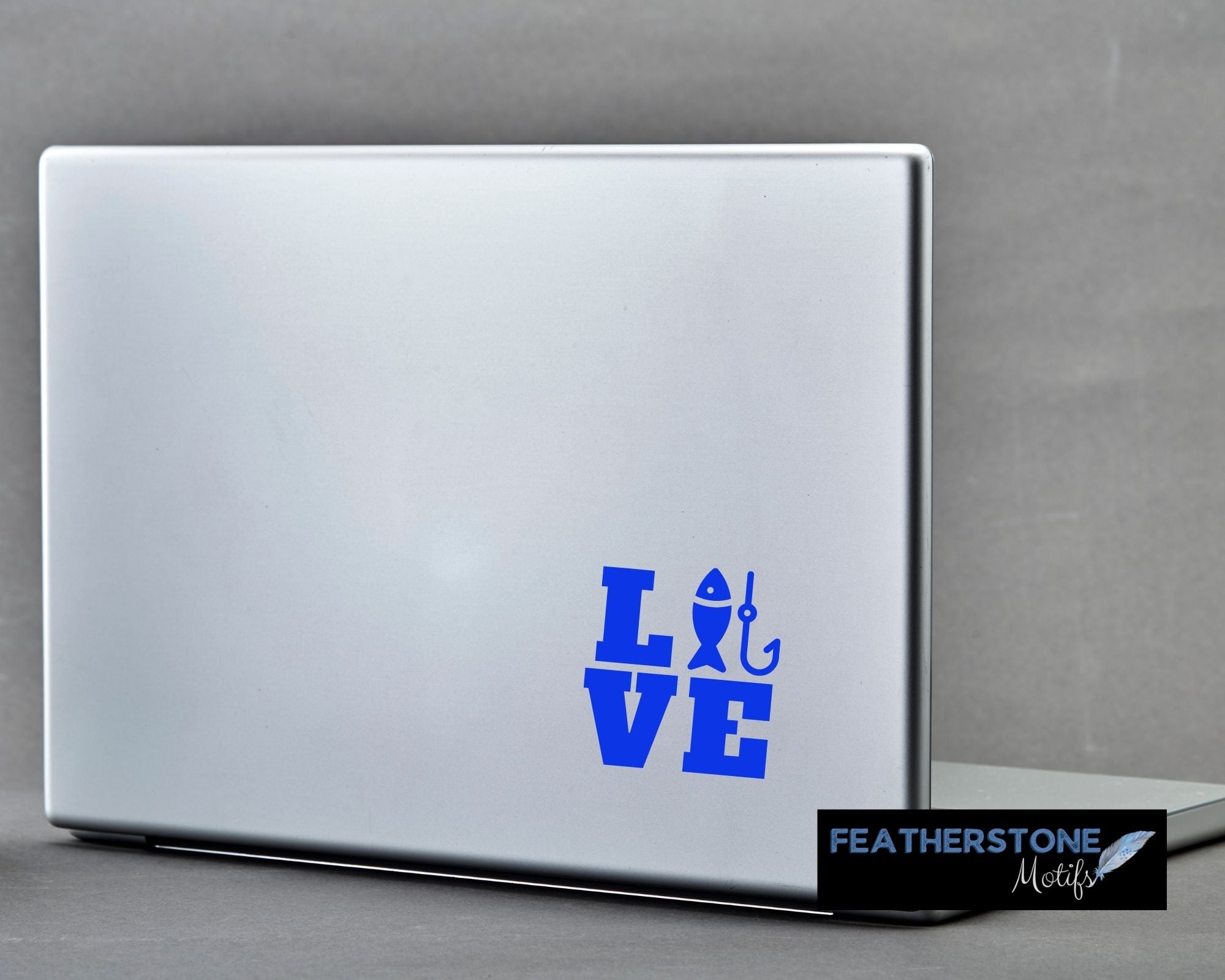 Love the fishing? Then show it with this fishing love square vinyl decal! Available in 4 sizes and 10 colors, these vinyl decals make great gifts for everyone. This image shows the Fishing Love Square vinyl decal on the back of an open laptop.