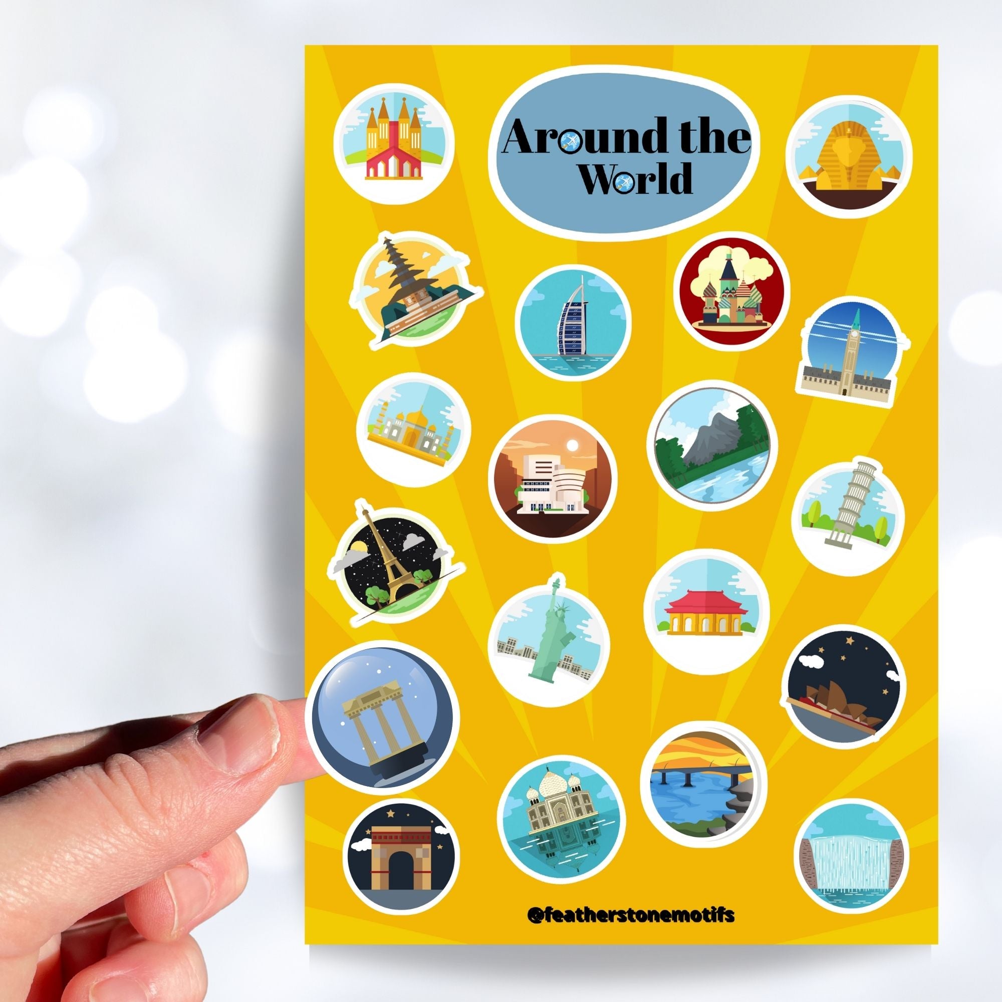 Our Around the World sticker sheet collection has sticker images of iconic travel destinations! This sheet has a yellow background with 20 different stickers. This image shows a hand holding a sticker of ancient ruins with a night starry background above the sticker sheet.