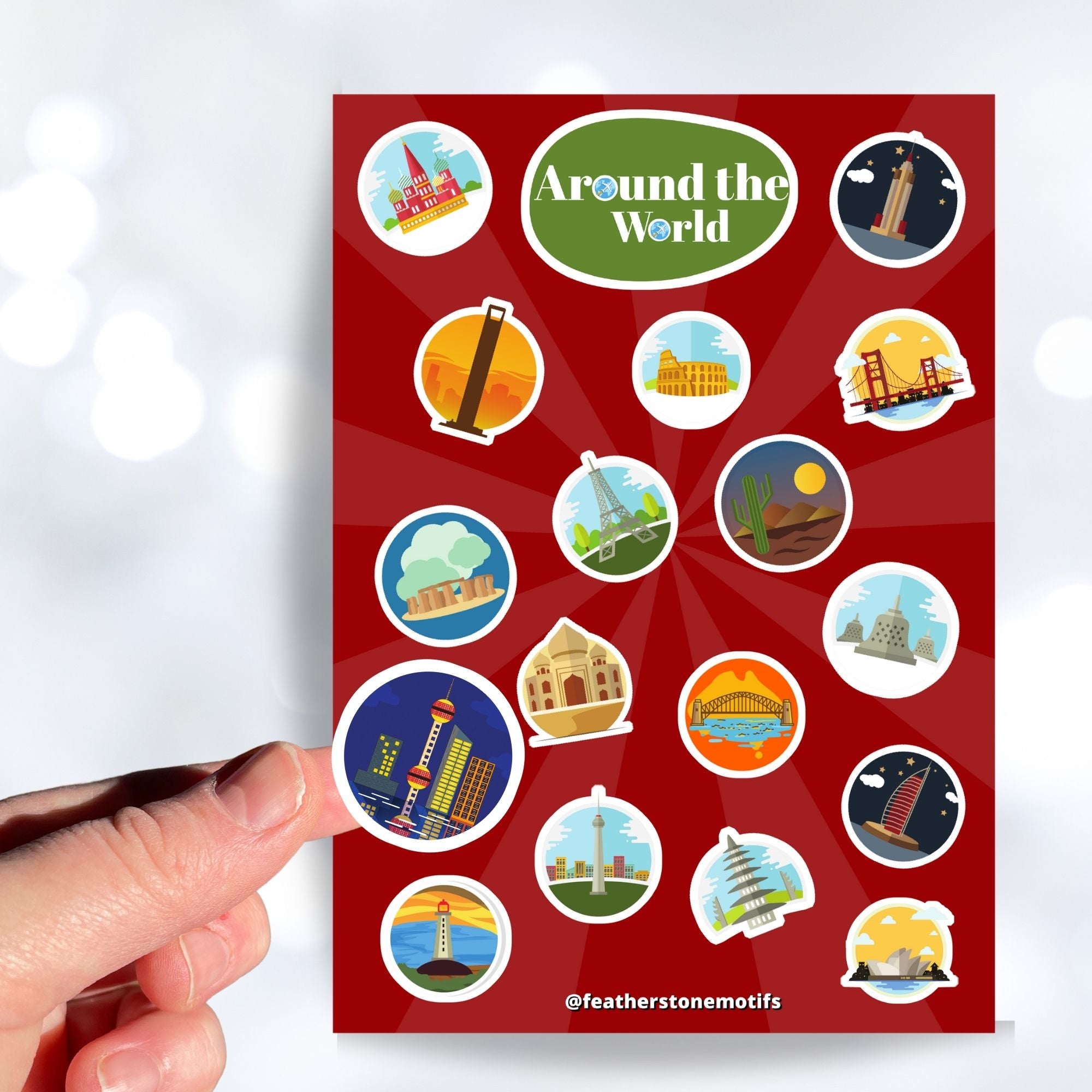 Our Around the World sticker sheet collection has sticker images of iconic travel destinations! This sheet has a red background with 18 different stickers. This image shows a hand holding a sticker of a night skyline above the sticker sheet.