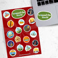 Load image into Gallery viewer, Our Around the World sticker sheet collection has sticker images of iconic travel destinations! This sheet has a red background with 18 different stickers. This image shows the sticker sheet next to an open laptop with the sticker sheet header saying "Around the World" in white on a green background applied below the keyboard.
