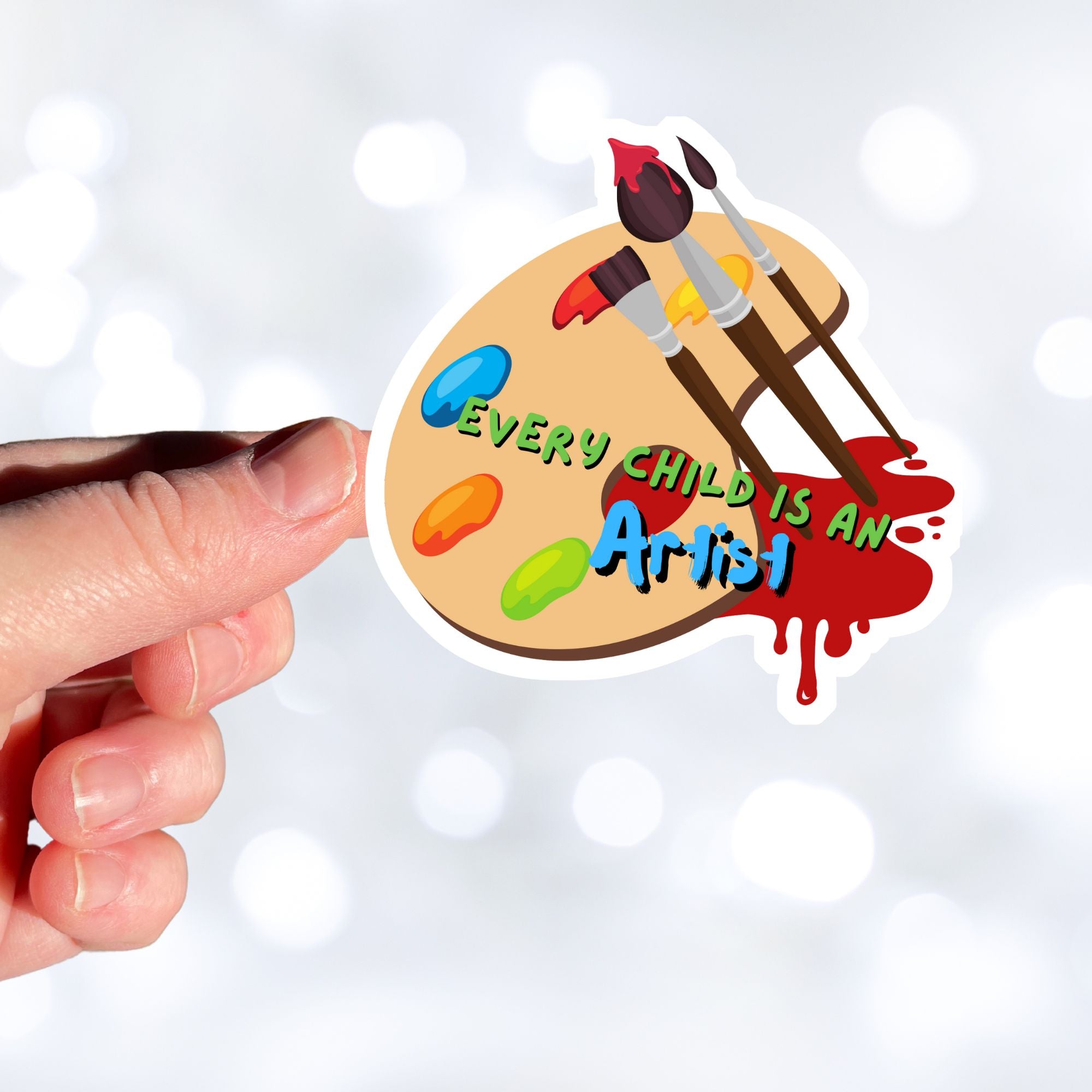 Whether for a child, or an inner child, this individual die-cut sticker is great for all artists! The Every Child is an Artist sticker has a paint palette and brushes to inspire you to create your next masterpiece. This image shows a hand holding the Every Child is an Artist sticker.