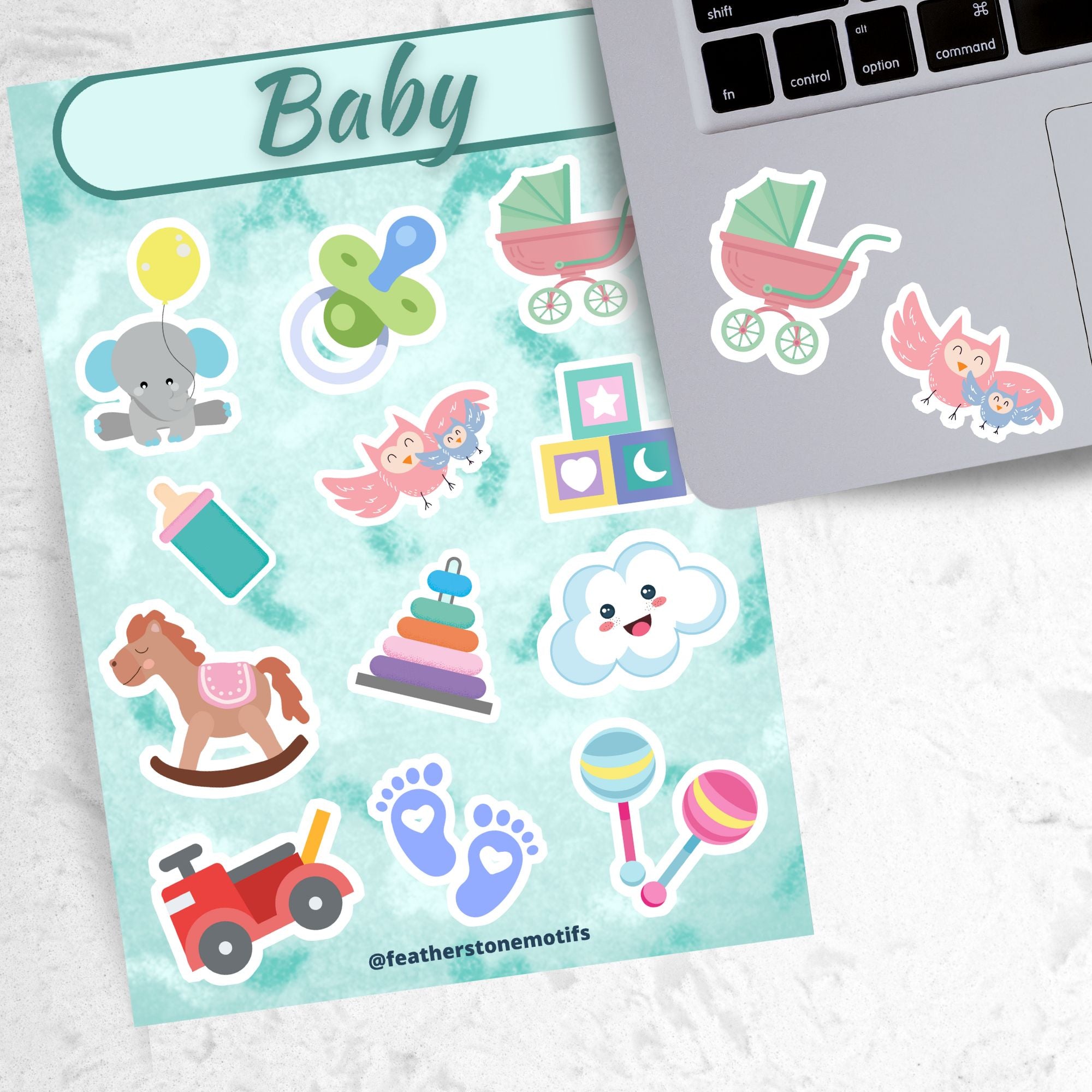 This sticker sheet has stickers showing everything a new parent would want for decorating or scrap booking! Images include a stroller, baby bottle, rocking horse, and even a baby elephant! This image shows the sticker sheet next to a laptop with 2 of the individual sticker below the keyboard.