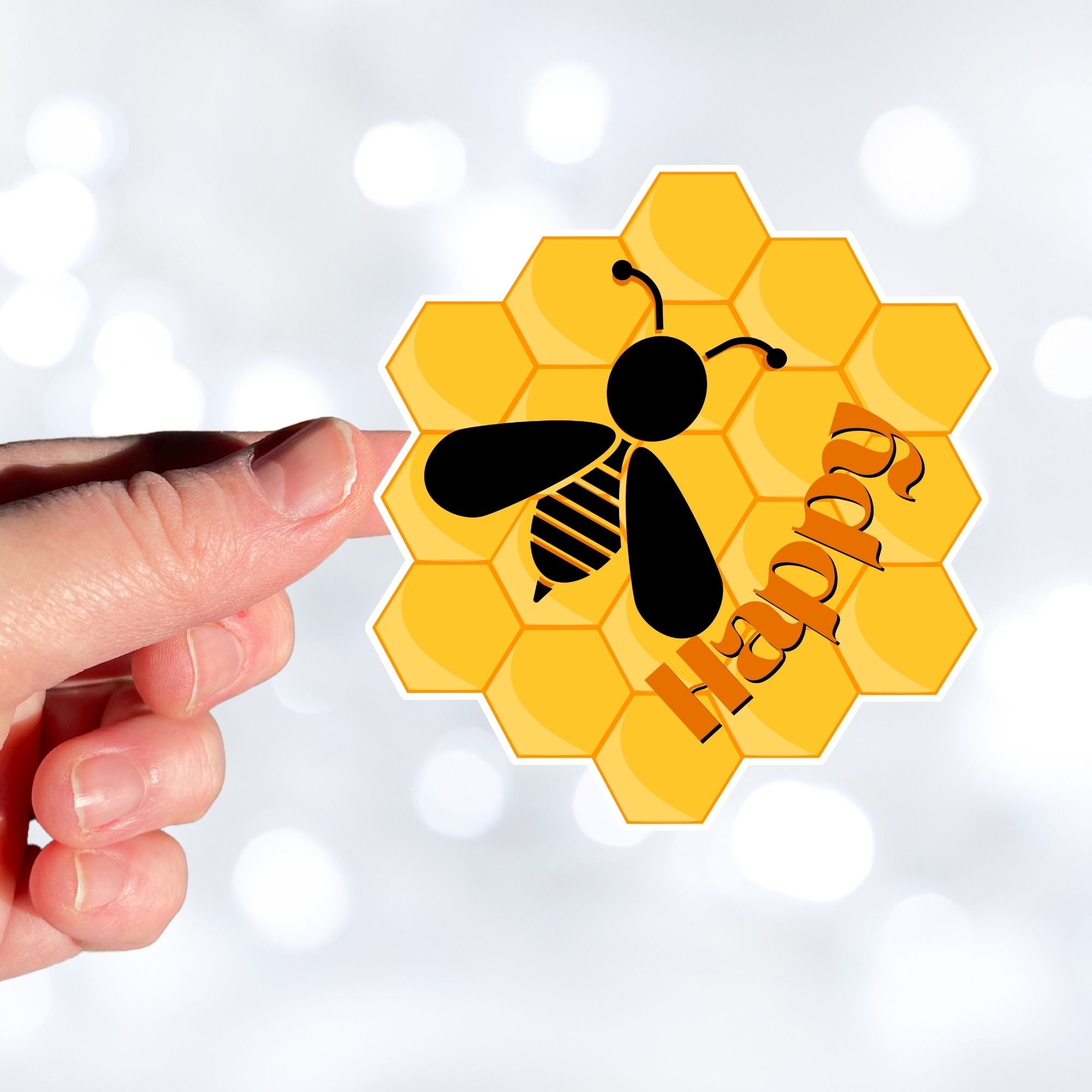 Bee Happy! This individual die-cut sticker is a great motivator. It features a honeycomb background with the silhouette of a bee and the word happy - enough said! This image shows a hand holding the Bee Happy sticker.