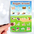 Load image into Gallery viewer, Butterflies, bees, worms, snails, and dragonfly's; this sticker sheet has cute stickers of all of your favorite bugs. This image shows a hand holding a snail sticker above the sticker sheet.

