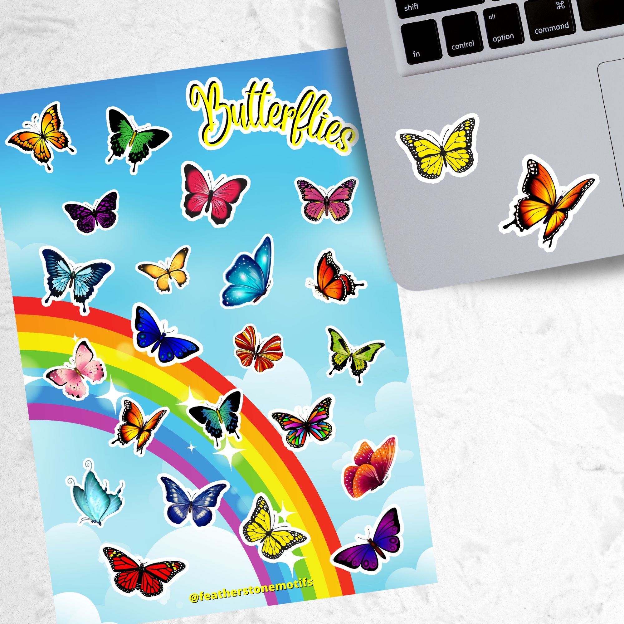 With over 20 butterfly stickers, this sticker sheet will be a sure hit with anyone who loves butterflies! This image shows the sticker sheet next to an open laptop with two Monarch butterfly stickers applied below the keyboard.