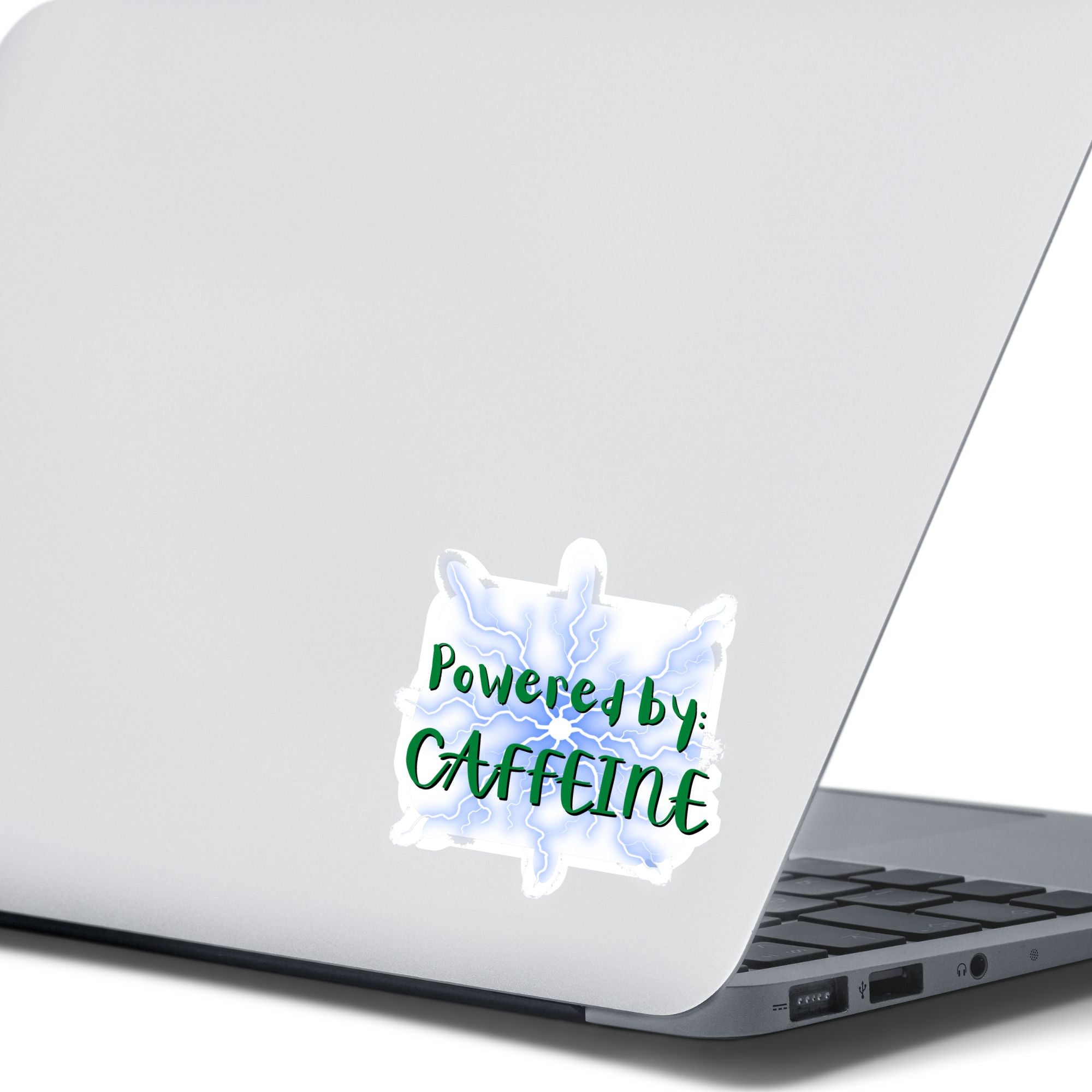 or those who like it, caffeine can be the magic elixir! This individual die-cut sticker has the words Powered by CAFFEINE in green over a background of blue electric/lightning bolts. This image shows the Powered by Caffeine sticker on the back of an open laptop.