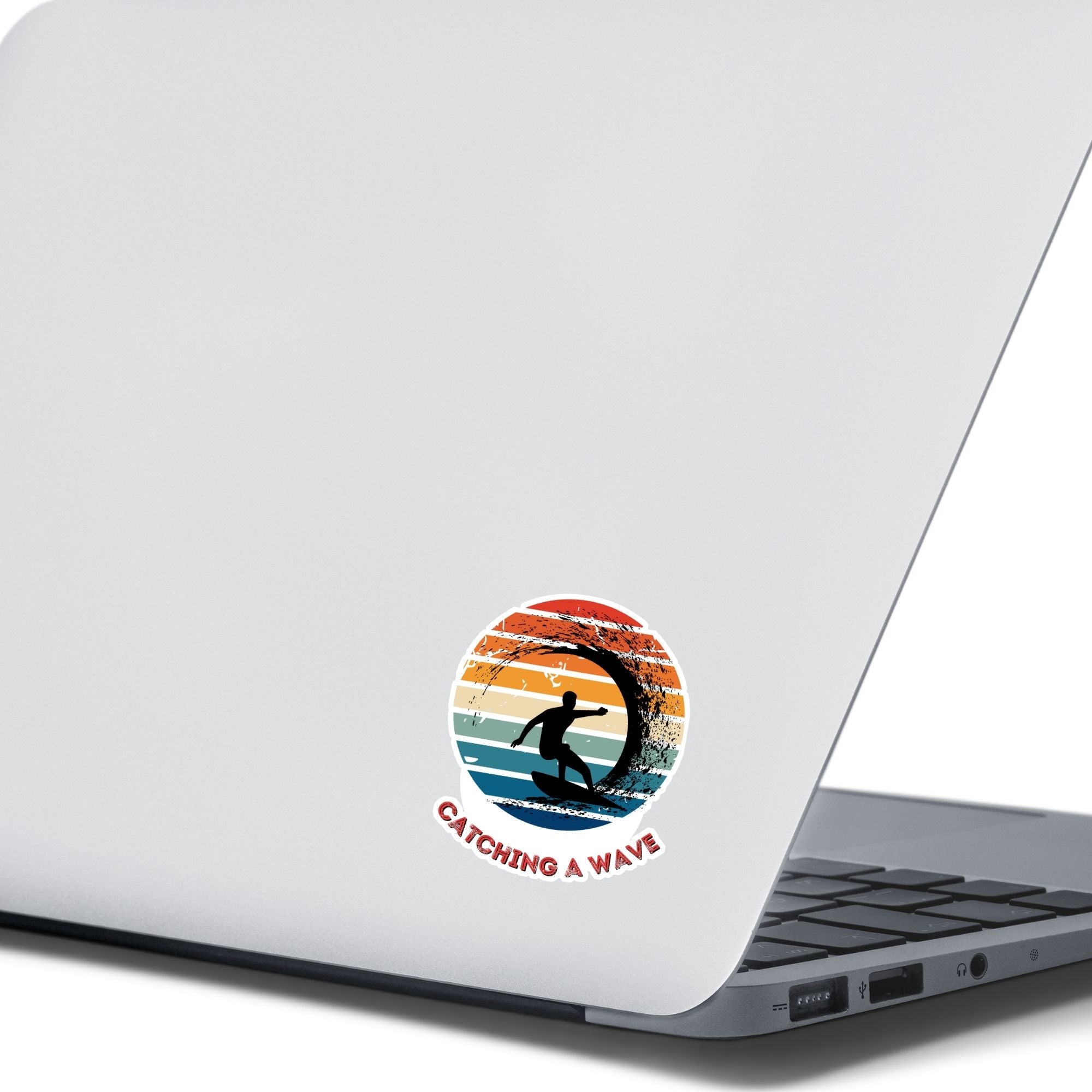 Hang 10 Bro! Catch a wave with this individual die-cut sticker featuring the silhouette of a male surfer inside the tube, all on a colored gradient background. Cowabunga!  This image shows the Catching a Wave sticker on the back of an open laptop.