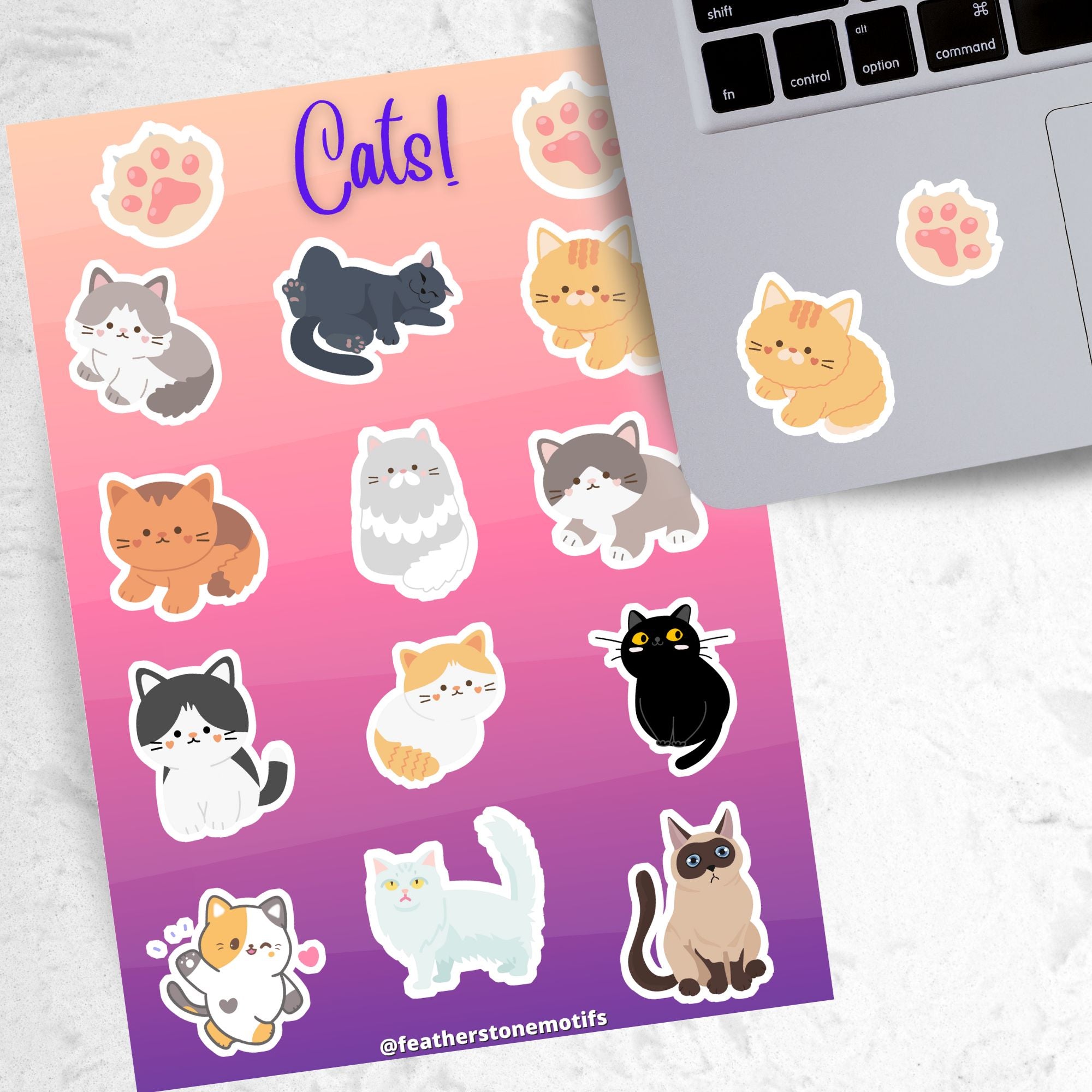 This sticker sheet is purrfect for all cat lovers! It has stickers of 12 different cute and cuddly cats, plus two pawprint stickers. This image shows the sticker sheet next to an open laptop with tan kitty and pawprint stickers below the keyboard.