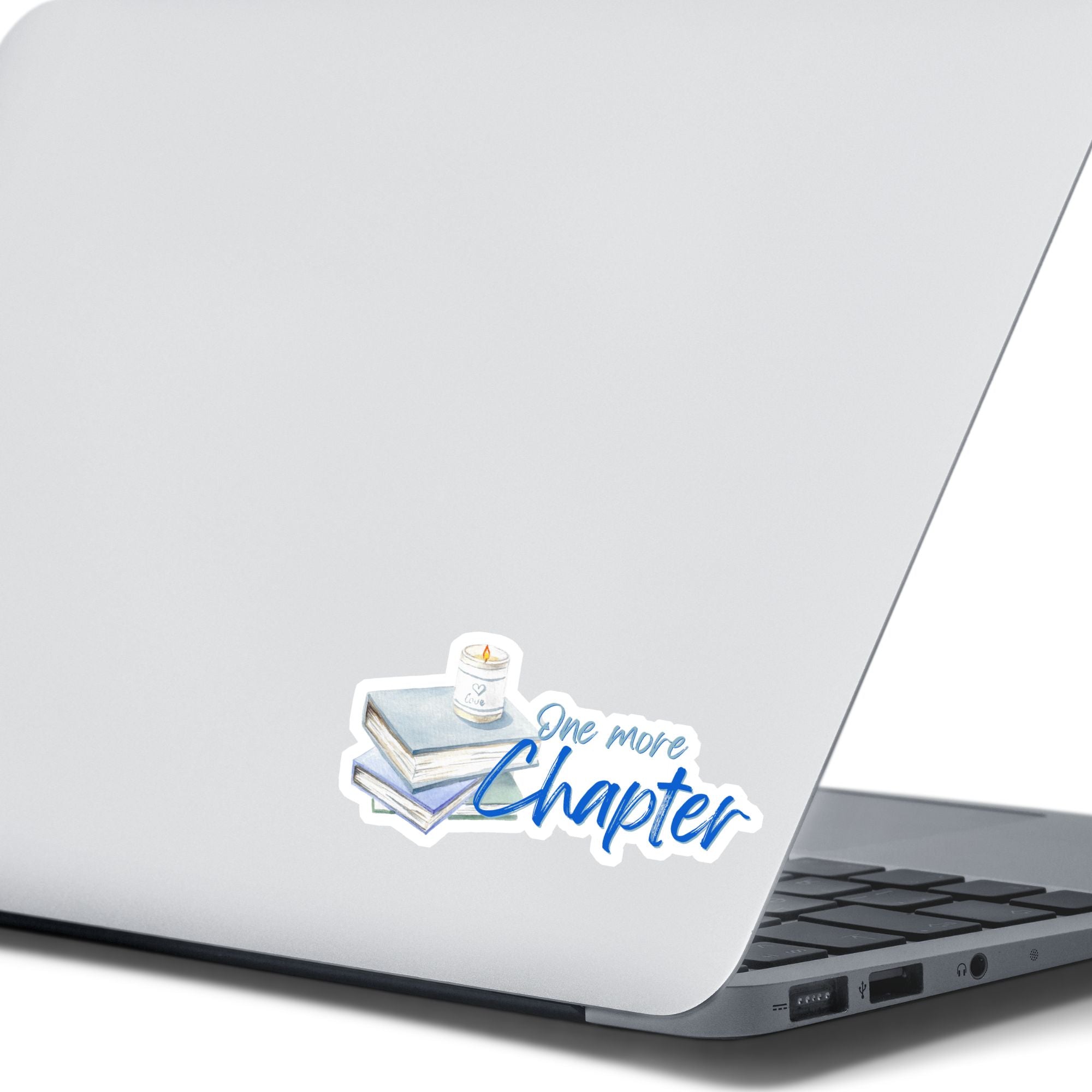 Love to read? If so then you know that there's always time for one more chapter! This individual die-cut sticker features a stack of books with a candle on top, and the words "One More Chapter", all in blue and gray on white. Enjoy your reading! This image shows the One More Sticker on the back of an open laptop.