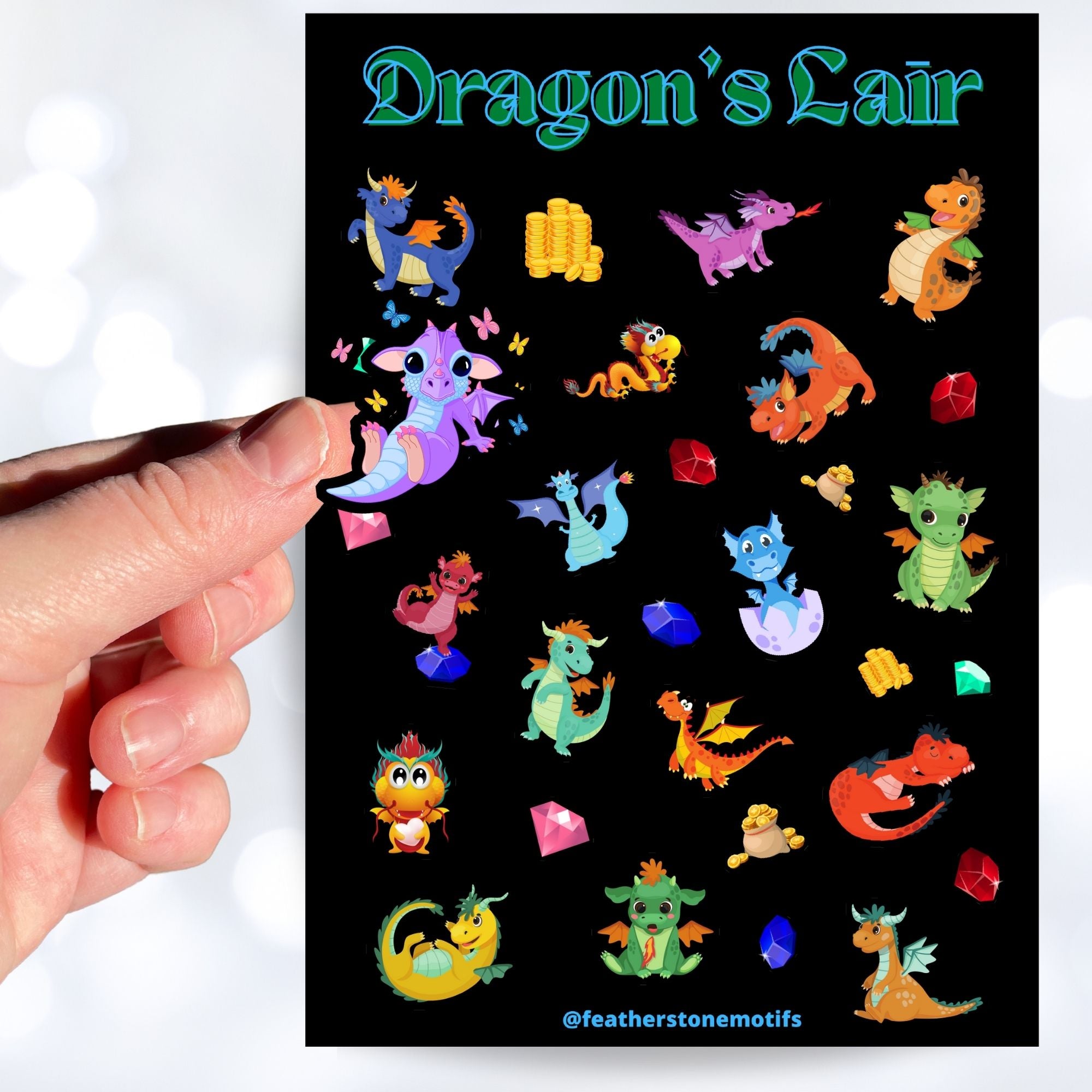 This sticker sheet is filled with cute images of baby dragons, and of course their treasure! This image shows a hand holding a sticker of a purple dragon sitting with butterflies flying around over the sticker sheet.