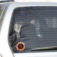 Load image into Gallery viewer, Who dares to disturb the Fire Dragon? This individual die-cut sticker features a fiery orange dragon surrounded by a ring of fire.  This image shows the Fire Dragon sticker on the back window of a car.
