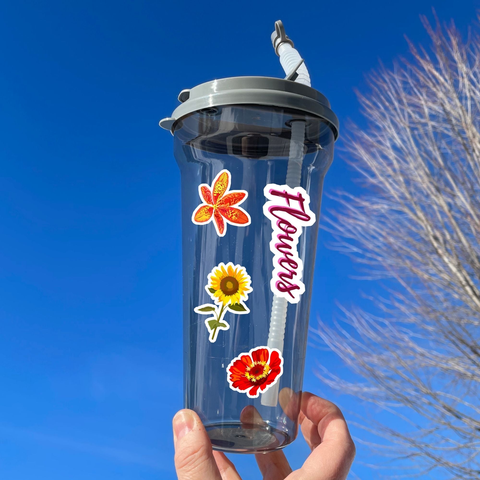 So many flowers! This sticker sheet is filled with images of all your favorite flowers. This image shows a water bottle with the sticker sheet header reading "Flowers", and three flower stickers applied to it.