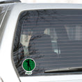 Load image into Gallery viewer, Show your love of golf with this individual die-cut sticker! This sticker shows the silhouette of a golfer with a ponytail about to swing, on a green golf ball background, with the word "Fore!" below.  This image shows the golf sticker on the back window of a car.
