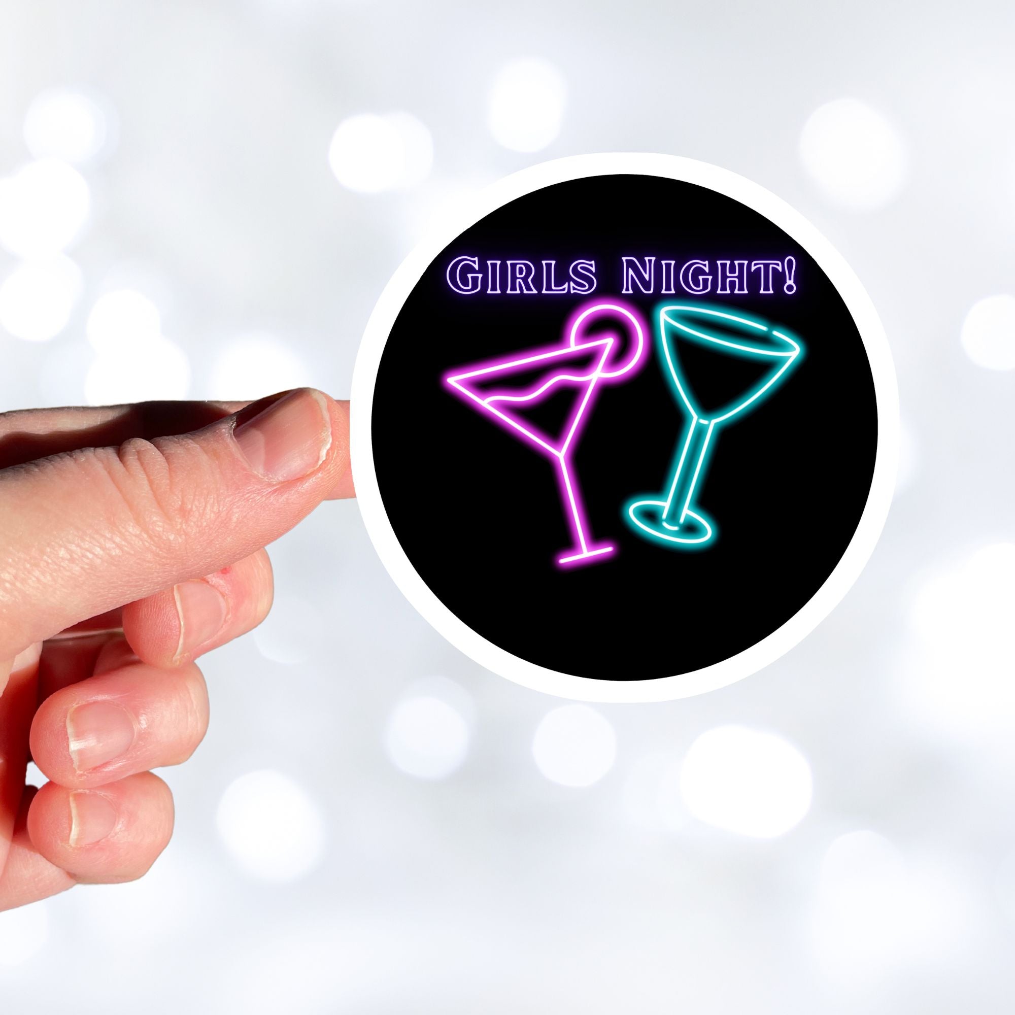 Ladies, it's time to hit the town! This neon die-cut sticker features a couple of cocktail glasses with "Girls Night!" written above. Enjoy! This image shows a hand holding the Girls Night sticker.