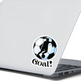 Load image into Gallery viewer, Show your love of soccer, or football, with this individual die-cut sticker! This sticker shows the silhouette of a player with a ponytail about to kick, on a black and white/blue soccer ball background, with the word "Goal!" below. This image shows the soccer sticker on the back of an open laptop.
