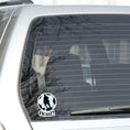 Load image into Gallery viewer, Show your love of soccer, or football, with this individual die-cut sticker! This sticker shows the silhouette of a player about to kick, on a black and white/blue soccer ball background, with the word "Goal!" below. This image shows the soccer sticker on the rear window of a car.
