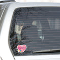 Load image into Gallery viewer, Show how much you love grandma with this individual die-cut sticker. This makes a great gift for grandma, or for all grandma's to proudly show they are a grandmother! This sticker features a red scribbled heart with Grandma written across the middle and 5 small paint hands on the lower left side. This image shows the Grandma sticker on the back window of a car.
