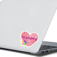 Load image into Gallery viewer, Show how much you love grandma with this individual die-cut sticker. This makes a great gift for grandma, or for all grandma's to proudly show they are a grandmother! This sticker features a red scribbled heart with Grandma written across the middle and 5 small paint hands on the lower left side. This image shows the Grandma sticker on the back of an open laptop.
