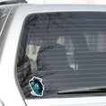 Load image into Gallery viewer, Welcome space aliens! This individual die-cut sticker features a friendly green space alien in a flying saucer, on a background of stars with the moon behind, and the words "Greetings Earthling". This image shows the flying saucer sticker on the rear window of a car.
