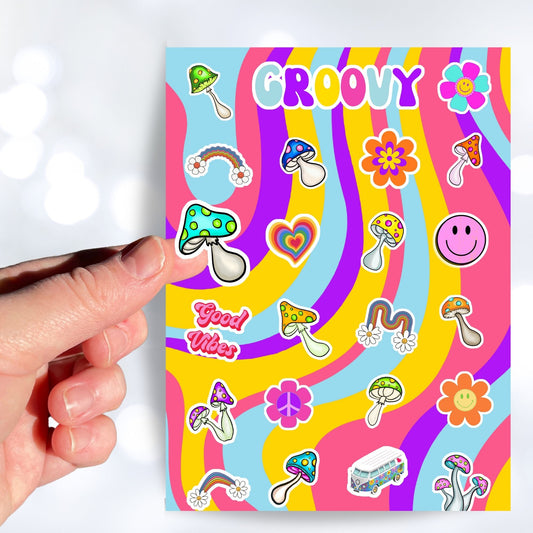Groovy man! This psychedelic sticker sheet is filled with images of rainbows, mushrooms, flowers, a smiley face, and even a VW Microbus! This image shows a hand holding a blue and green topped mushroom over the sticker sheet.