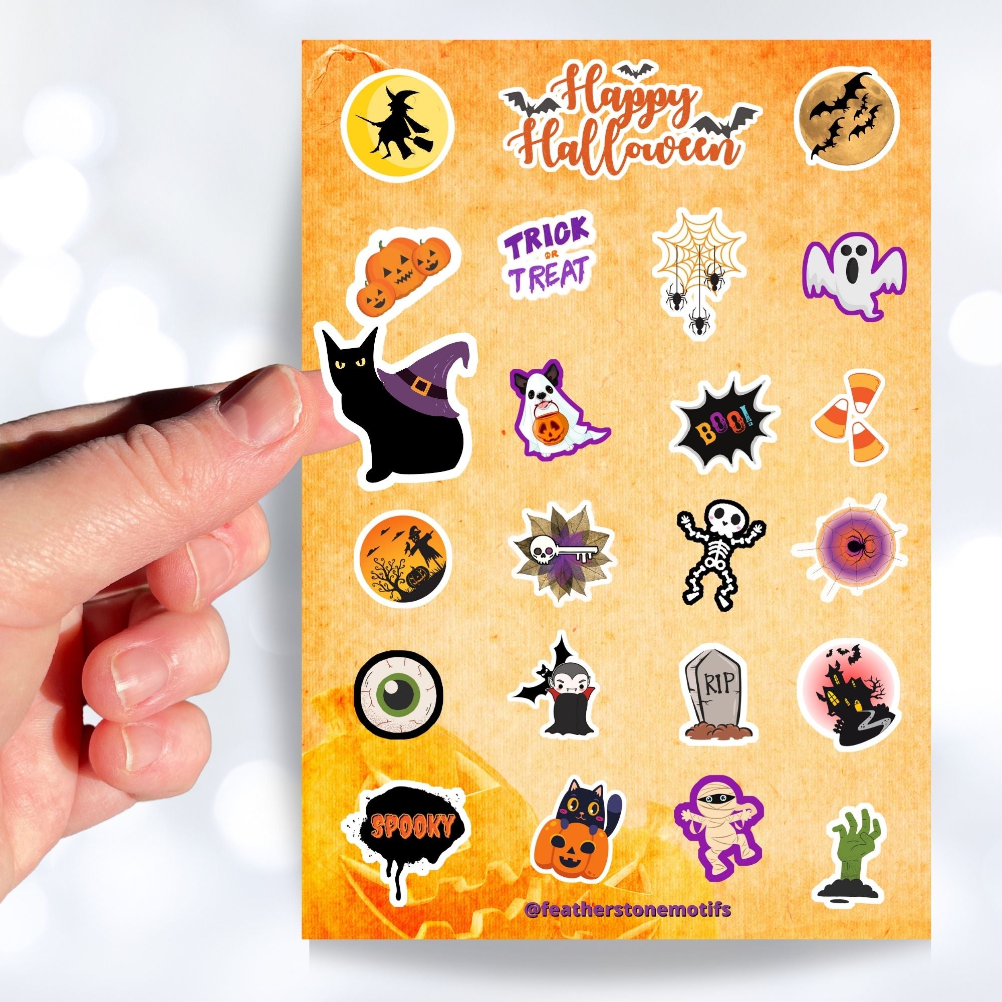 Ghosts, skeletons, black cats, and spiders; this spooky but fun sticker sheet is perfect for your Halloween decorating! This image shows a hand holding a sticker of a black cat with a witches had on it's back over the sticker sheet.