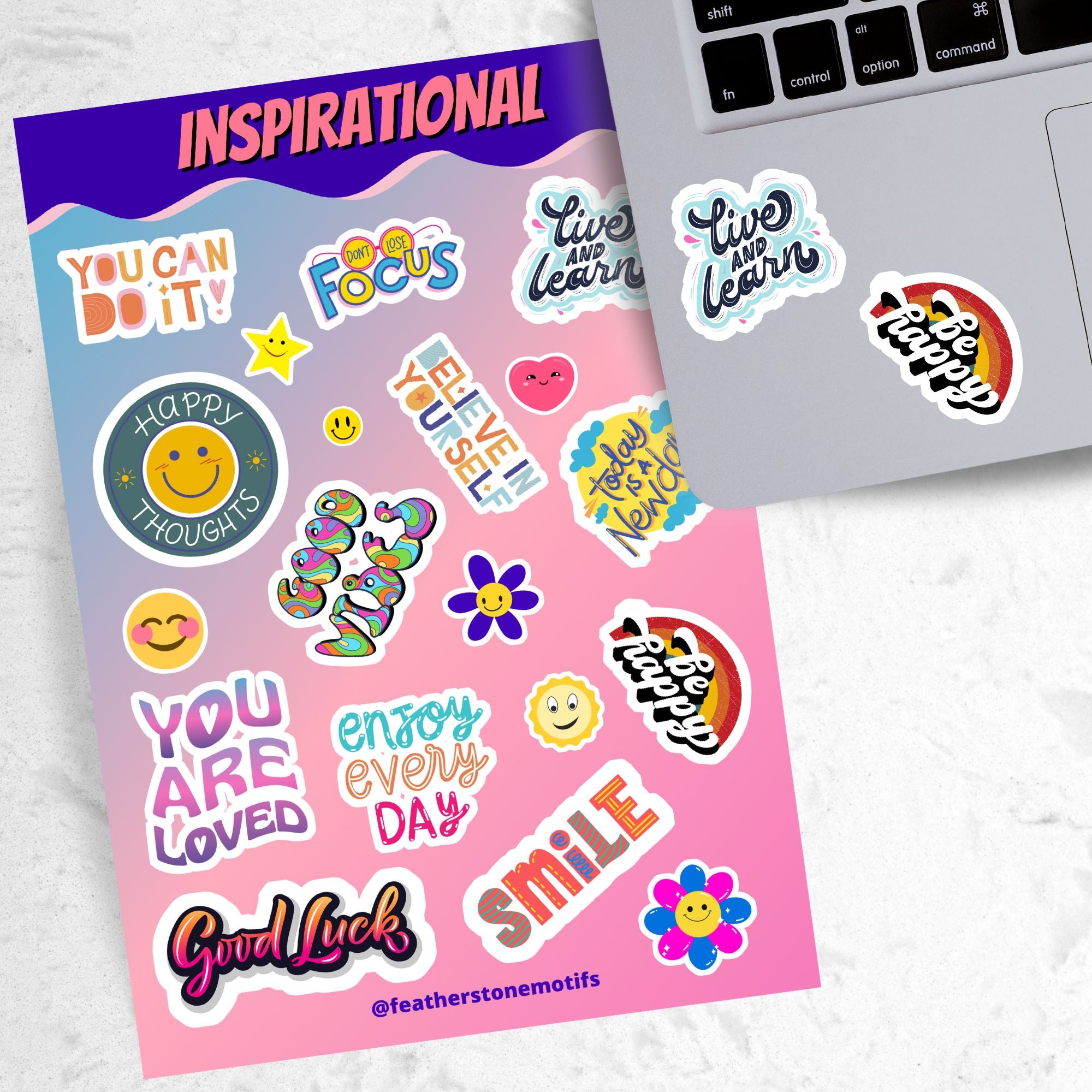 Feel good with these inspirational thoughts as stickers! This sheet has a dozen stickers with inspirational sayings, plus some smaller stickers to help brighten anyone's day. This image shows the sticker sheet next to an open laptop with a "Live and Learn" sticker and a "Be Happy" sticker applied below the keyboard.