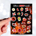Load image into Gallery viewer, Hot peppers, hot salsa, and hot sauce; this sticker sheet is filled with stickers to celebrate everything spicy! This image shows a hand holding a sticker of a pepper on a fork with a red background above the sticker sheet.
